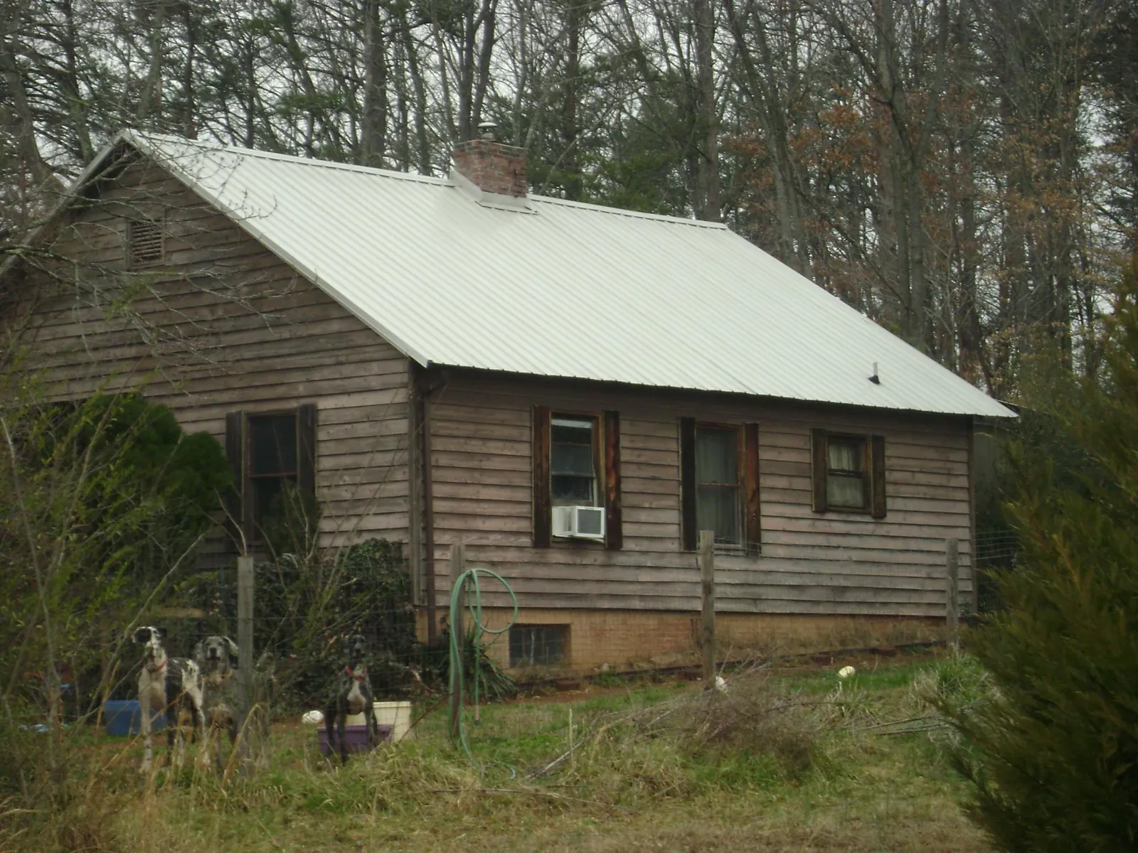White metal roof on an old wood sided farmhouse, from a Metal Roof Installation job in Summit Point